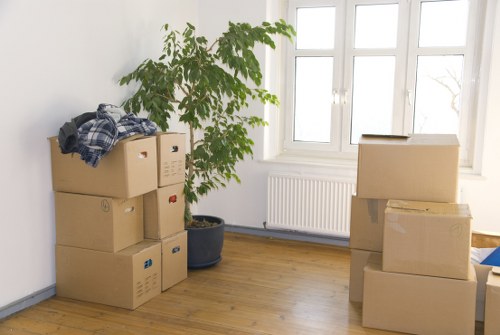 Movers carrying furniture down stairs in a Camden flat