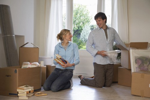 Professional movers loading household furniture into a truck